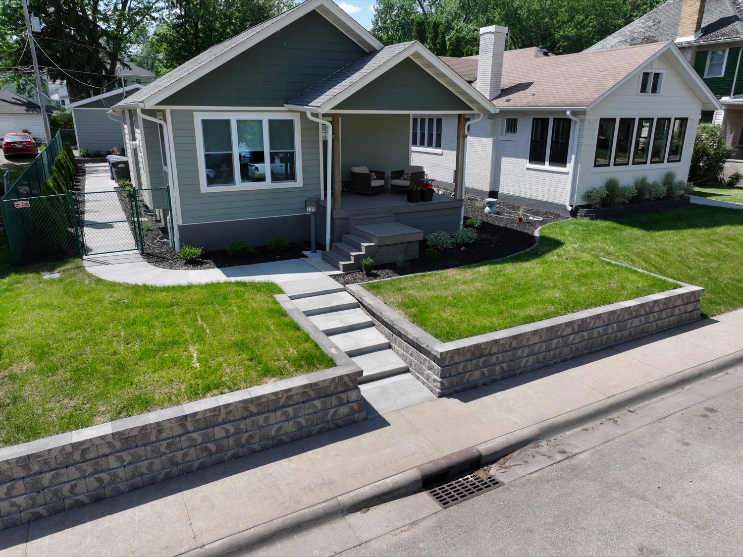 Terraced segmental block retaining wall with integrated steps built by Petersen Landscaping in the Quad Cities